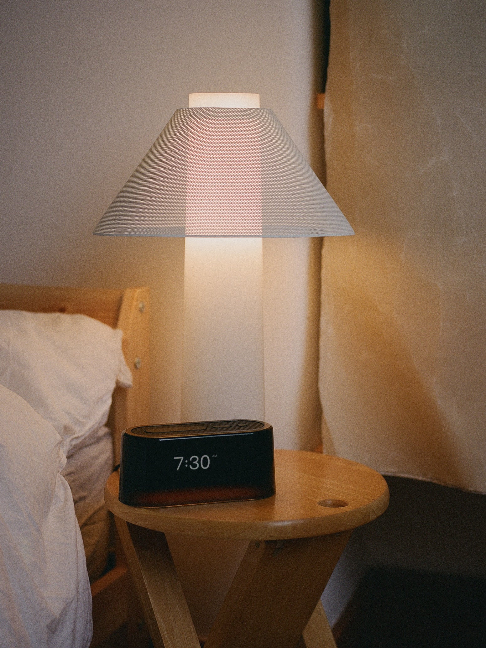 Loftie Clock and Loftie Lamp glowing on a nightstand